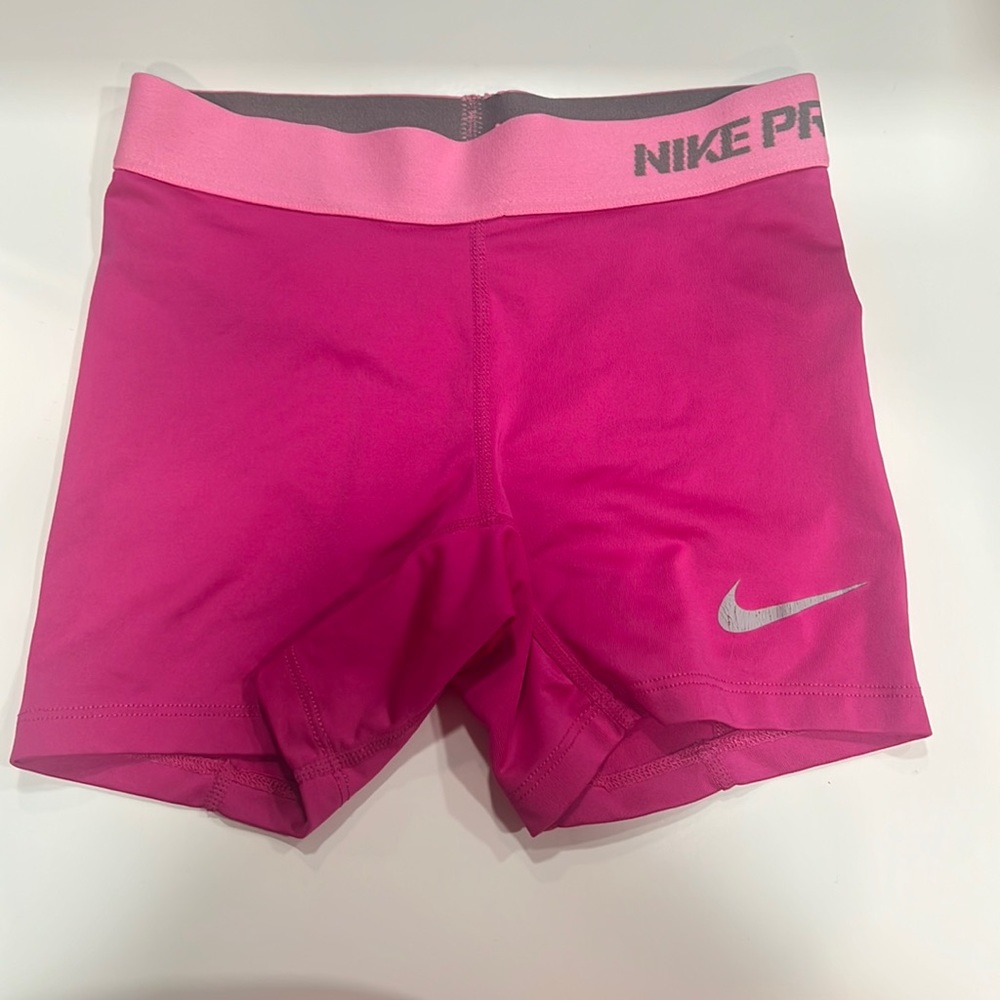 Pink Nike Pro Dri-Fit athletic shorts